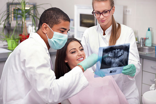 dental nurse examining patient's teeth