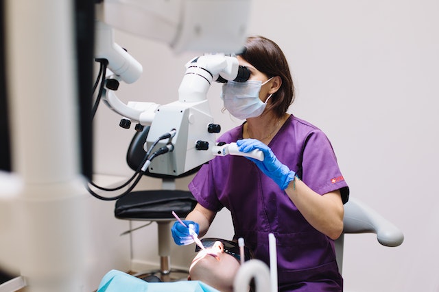 Dentist at work using advanced, almost futuristic equipment